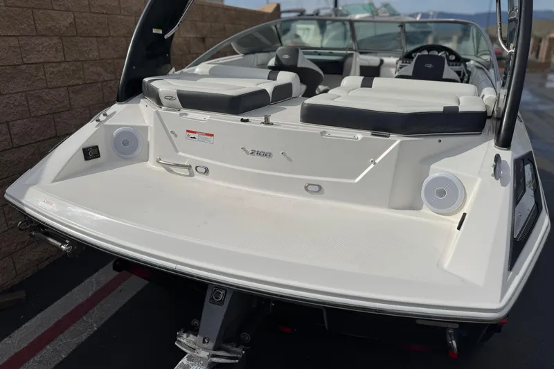 Slide: The Image of 2018 Regal 2100 Bowrider boat, rear view with seating and speakers. - 6