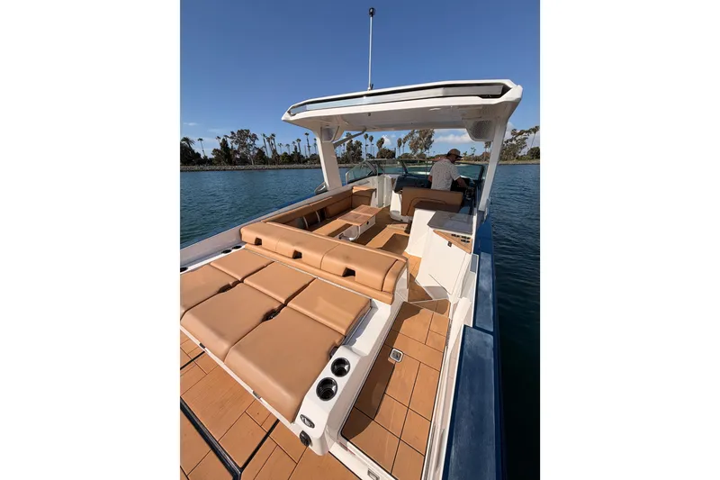Slide: The Image of 2022 Aviara AV32 I/O luxury boat with tan seating on a sunny day. - 10