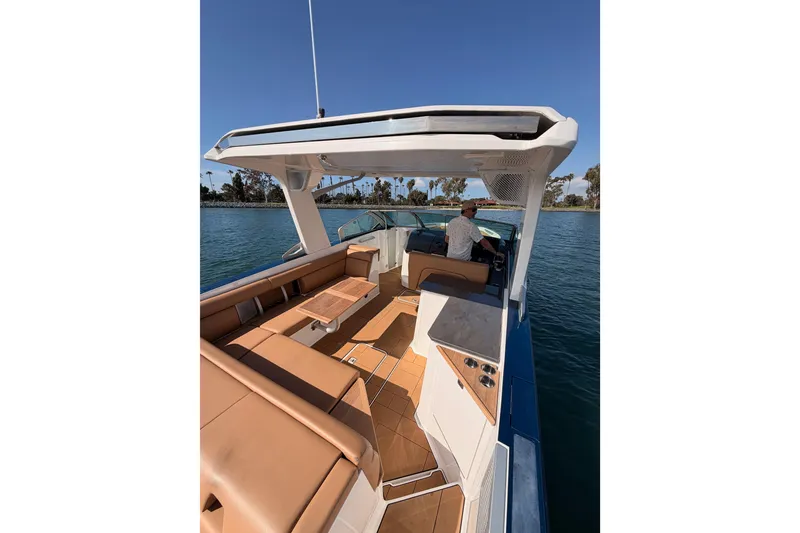 Slide: The Image of 2022 Aviara AV32 I/O boat with spacious seating and modern design on the water. - 11