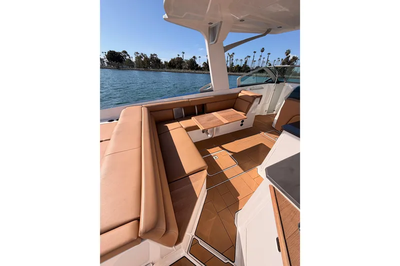 Slide: The Image of Luxurious 2022 Aviara AV32 I/O boat interior with tan seating and wooden accents on a sunny day. - 12