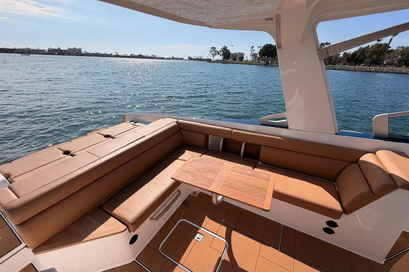 Slide: The Image of Luxurious seating area on 2022 Aviara AV32 I/O boat, overlooking serene waters. - 13