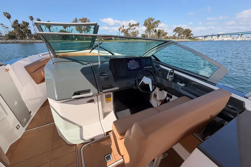 Slide: The Image of 2022 Aviara AV32 I/O boat interior with modern dashboard and scenic water view. - 17