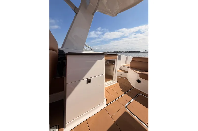 Slide: The Image of 2022 Aviara AV32 I/O boat interior with seating and cabinetry, overlooking water. - 26
