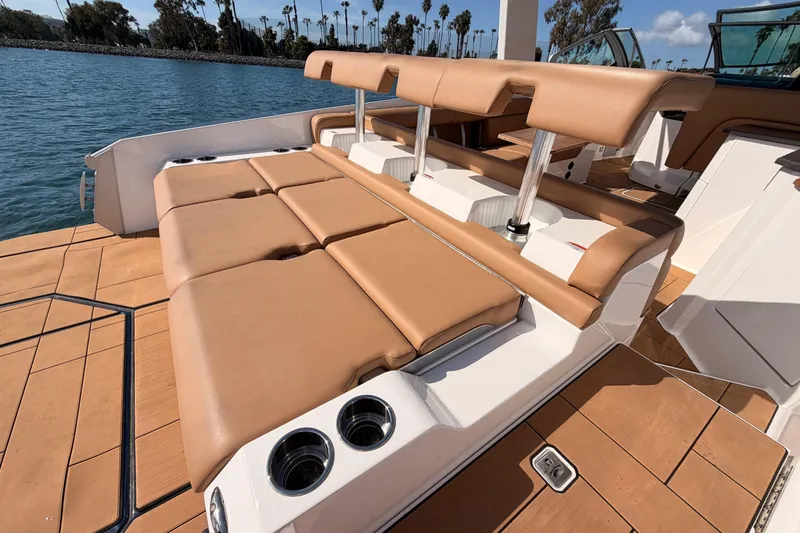 Slide: The Image of Luxury seating on 2022 Aviara AV32 I/O boat with tan upholstery and cup holders. - 28
