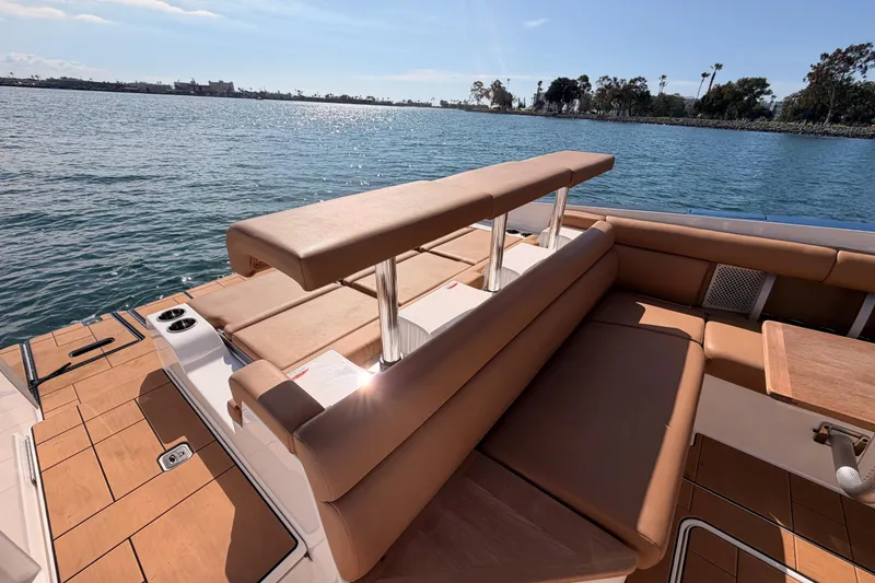 Slide: The Image of 2022 Aviara AV32 I/O boat with luxurious seating, docked by a serene waterfront. - 29