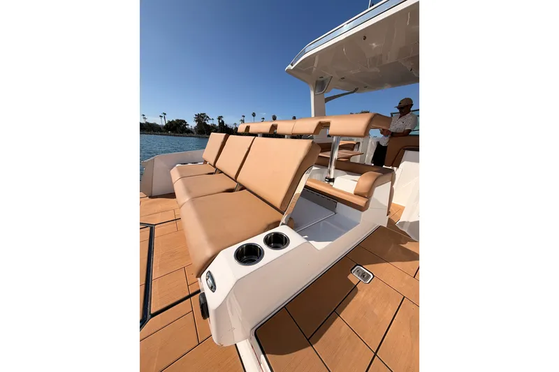 Slide: The Image of 2022 Aviara AV32 I/O boat with tan leather seating and cup holders on deck. - 30