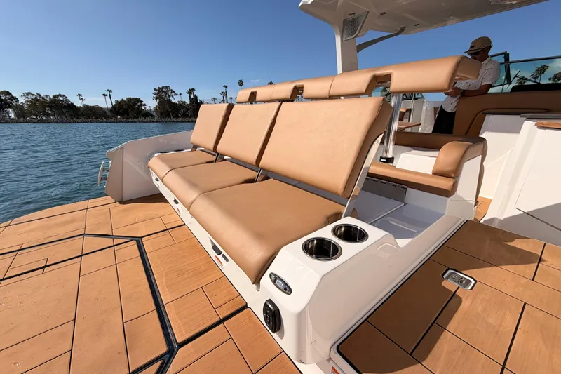 Slide: The Image of 2022 Aviara AV32 I/O boat with tan seating and cup holders on deck. - 31