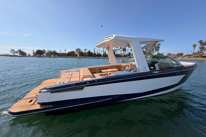 Slide: The Image of 2022 Aviara AV32 I/O boat on calm water, featuring sleek design and spacious seating. - 33