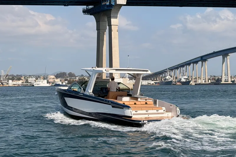 Slide: The Image of 2022 Aviara AV32 I/O boat cruising under a bridge on a sunny day. - 35