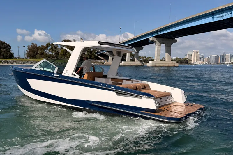 Slide: The Image of 2022 Aviara AV32 I/O boat cruising under a bridge on a sunny day. - 39