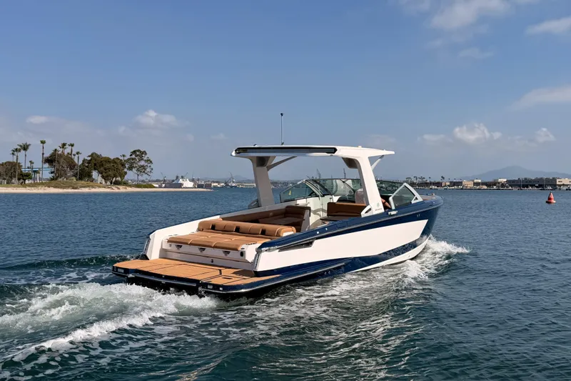 Slide: The Image of 2022 Aviara AV32 I/O boat cruising on a sunny day in open water. - 4