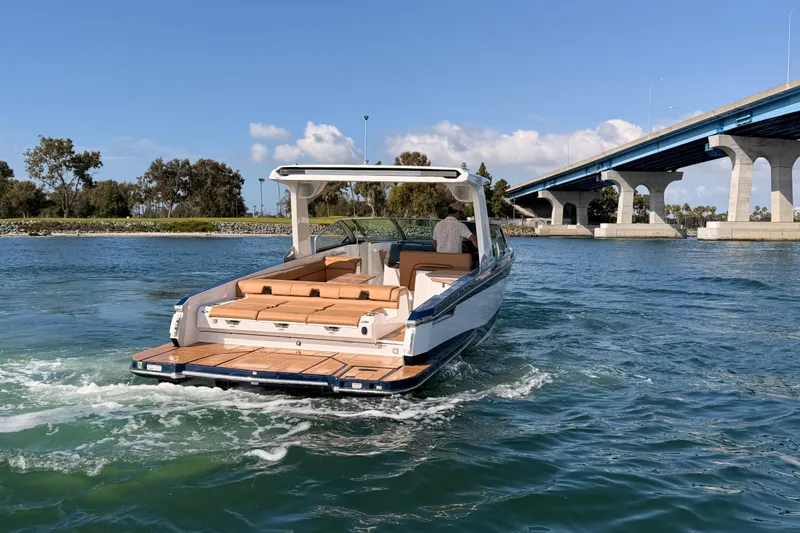 Slide: The Image of 2022 Aviara AV32 I/O boat cruising near a bridge on a sunny day. - 41