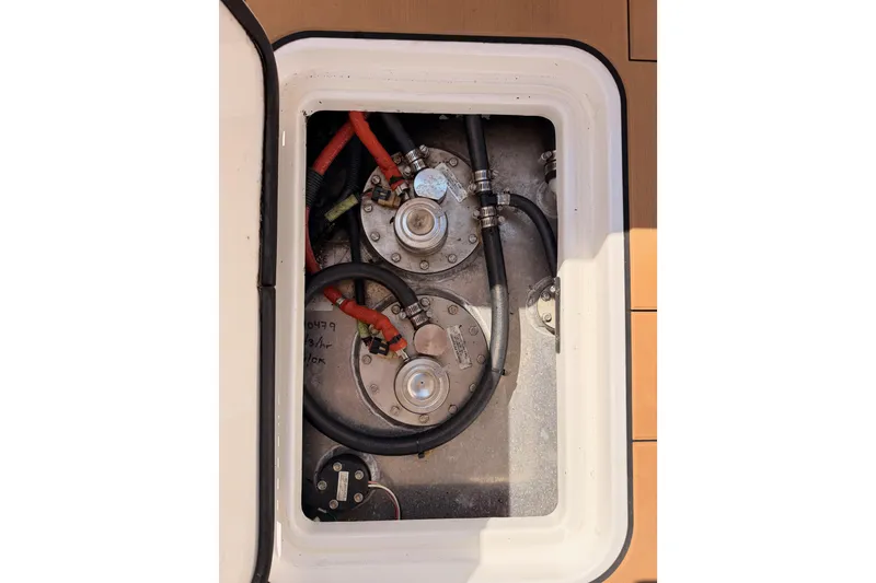 Slide: The Image of Fuel tank compartment of 2022 Aviara AV32 I/O boat with visible hoses and fittings. - 49