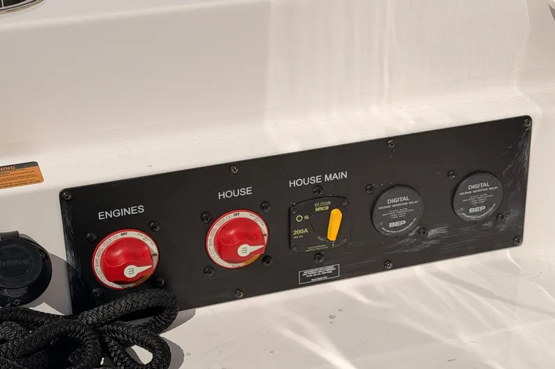 Slide: The Image of Control panel of a 2022 Aviara AV32 I/O boat with engine and house switches. - 52