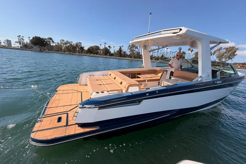 Slide: The Image of 2022 Aviara AV32 I/O boat on water, featuring sleek design and spacious seating. - 9