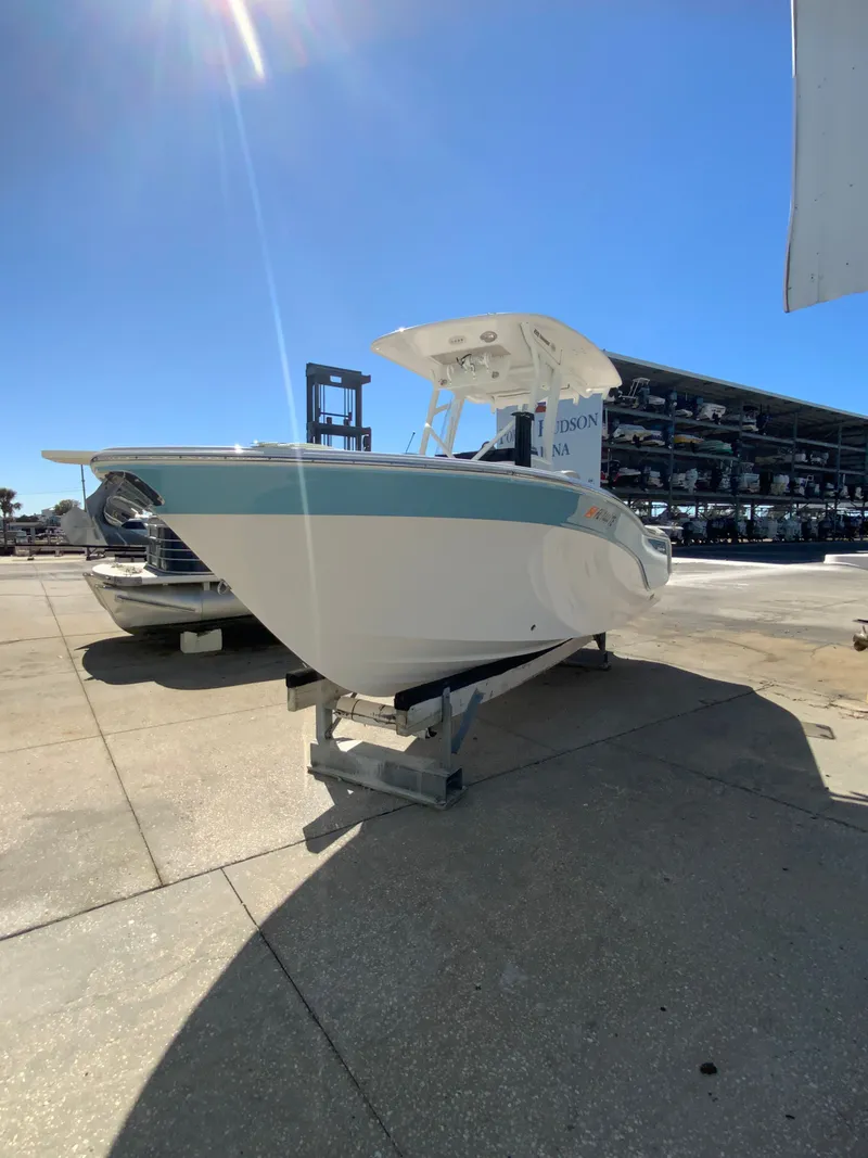 Slide: The Image of 2022 Sea Fox 228 Commander boat on a dock under sunny skies. - 13