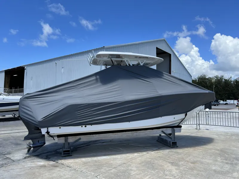 Slide: The Image of Covered 2022 Sea Fox 228 Commander boat outside warehouse. - 2