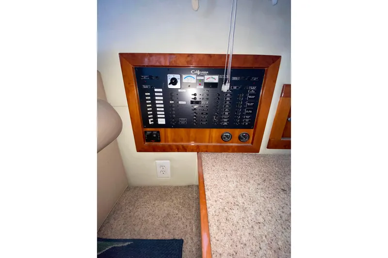 Slide: The Image of Electrical panel of a 2001 Californian 39 yacht, featuring switches and gauges. - 18