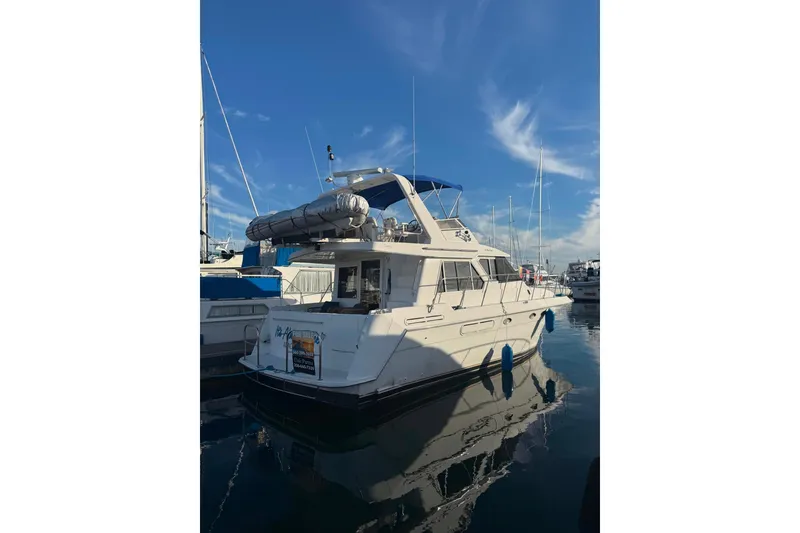 Slide: The Image of 2001 Californian 39 yacht docked at marina under clear blue sky. - 2