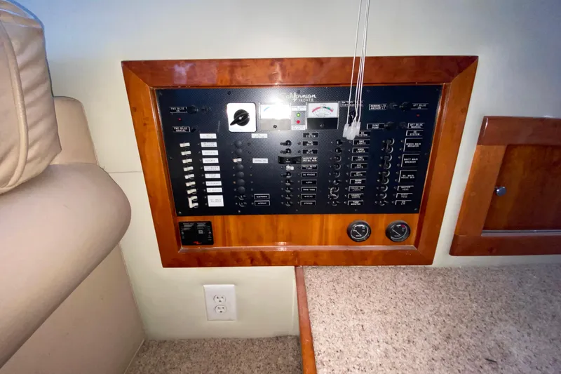 Slide: The Image of Electrical control panel on a 2001 Californian 39 yacht, featuring switches and gauges. - 21