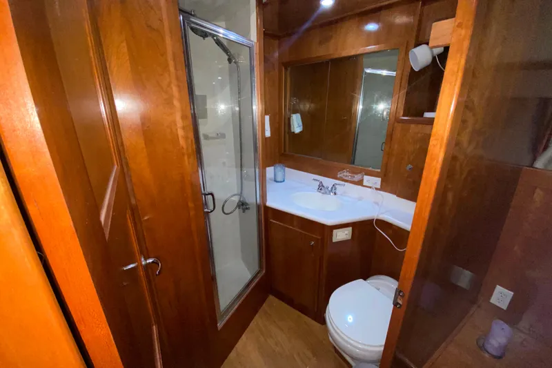 Slide: The Image of Luxurious wooden bathroom interior in 2001 Californian 39 yacht, featuring shower and vanity. - 25
