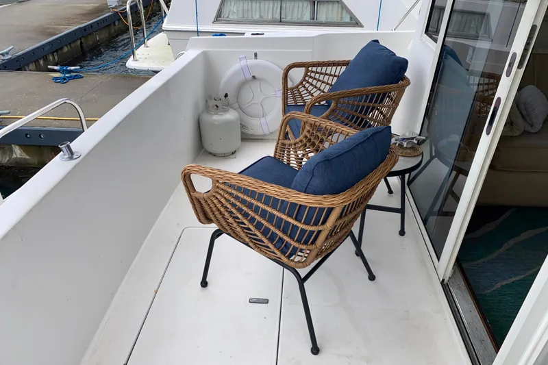 Slide: The Image of Deck of 2001 Californian 39 yacht with wicker chairs and blue cushions. - 27