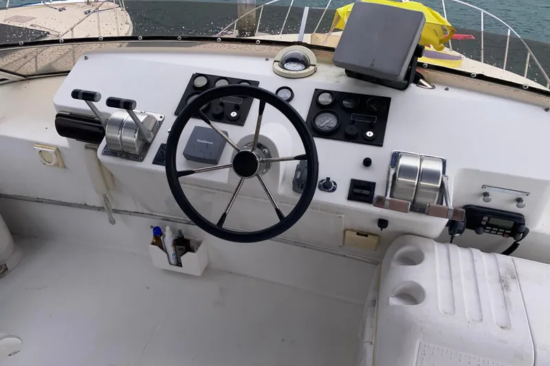 Slide: The Image of Boat helm of a 2001 Californian 39, featuring steering wheel and control panel. - 29