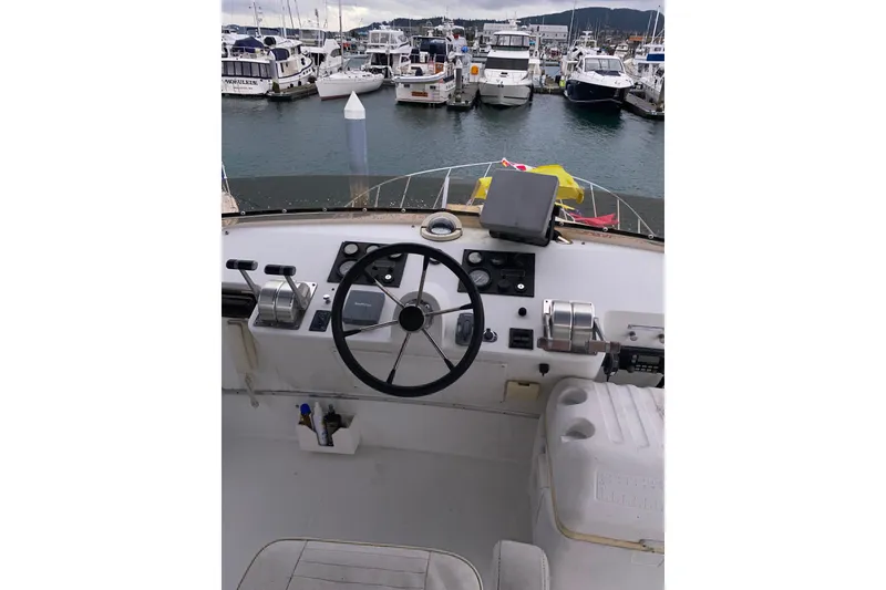 Slide: The Image of Helm of 2001 Californian 39 boat with marina view in background. - 30