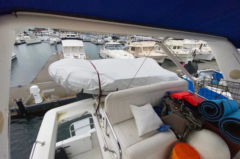 Slide: The Image of 2001 Californian 39 yacht interior with marina view, featuring seating and covered equipment. - 32