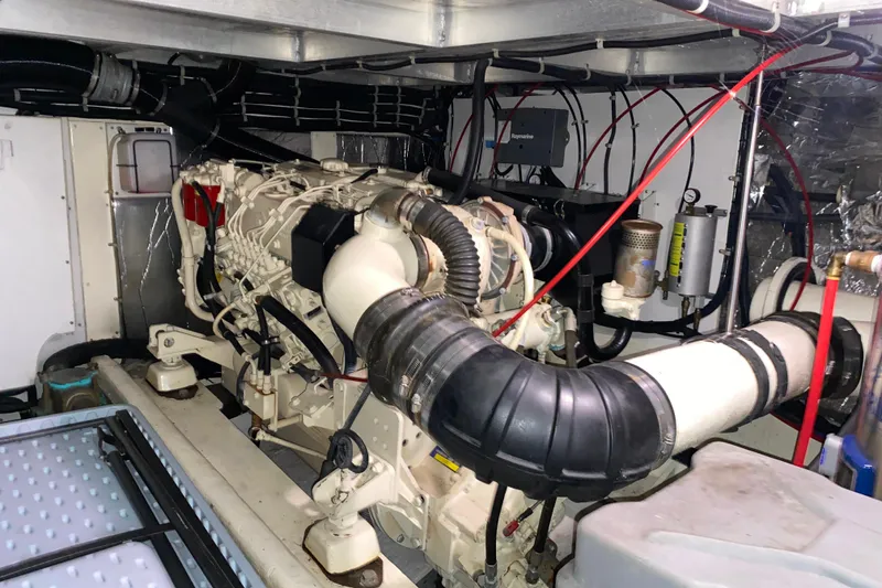 Slide: The Image of Engine room of a 2001 Californian 39 yacht, showcasing complex machinery and wiring. - 34
