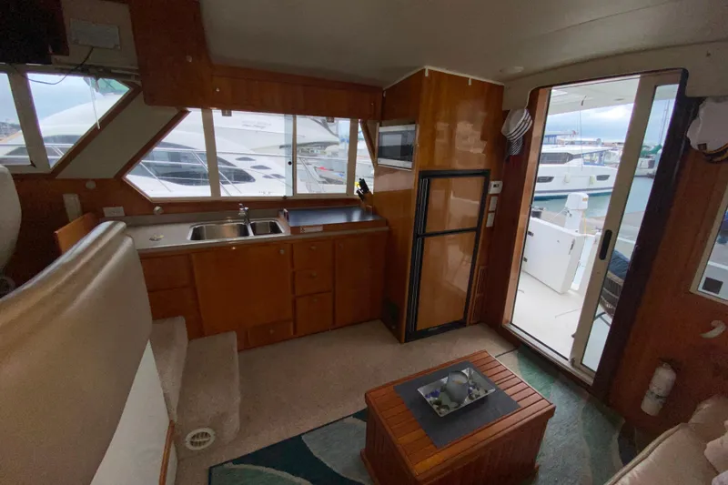 Slide: The Image of Interior of 2001 Californian 39 yacht with kitchenette and marina view. - 7