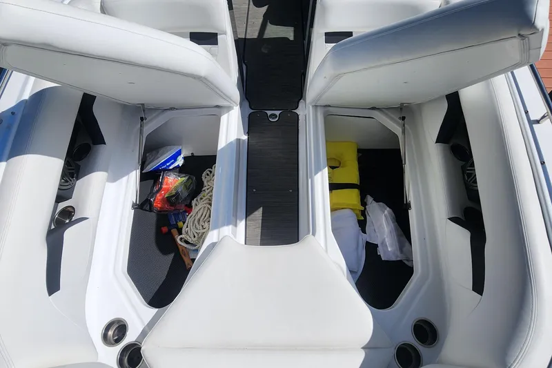 Slide: The Image of 2023 Four Winns HD8 OB boat interior storage compartments with safety gear and accessories. - 11