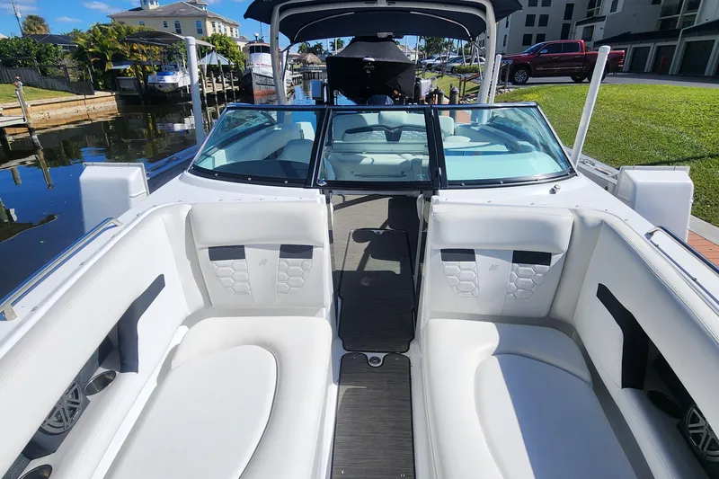 Slide: The Image of 2023 Four Winns HD8 OB boat interior with white seating and sleek design. - 17