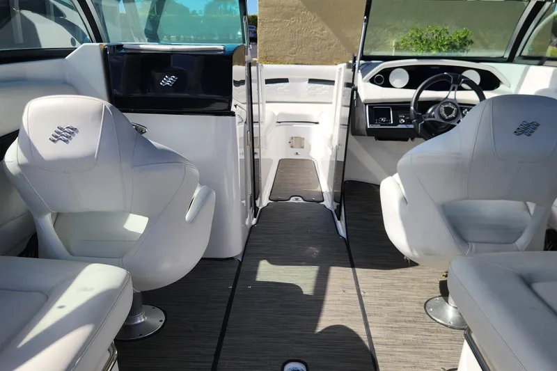 Slide: The Image of 2023 Four Winns HD8 OB boat interior with white seating and modern dashboard. - 18