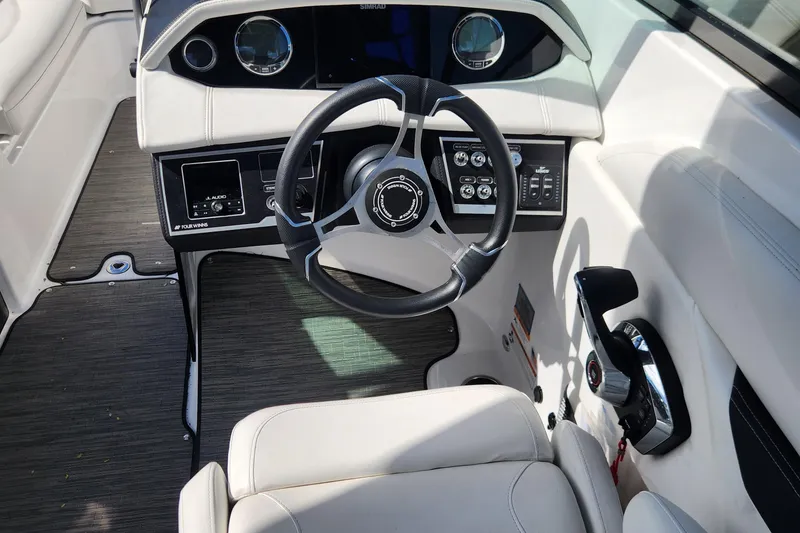 Slide: The Image of 2023 Four Winns HD8 OB boat cockpit with steering wheel and control panel. - 19