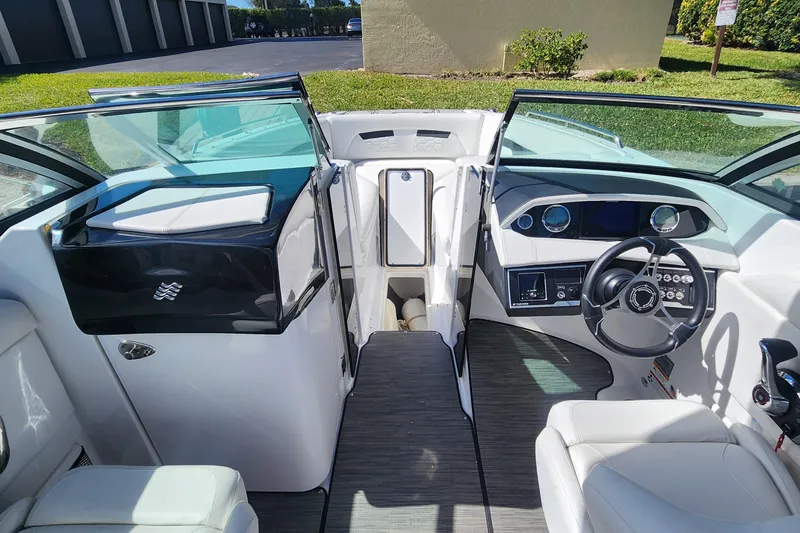Slide: The Image of 2023 Four Winns HD8 OB boat interior with modern dashboard and seating. - 21