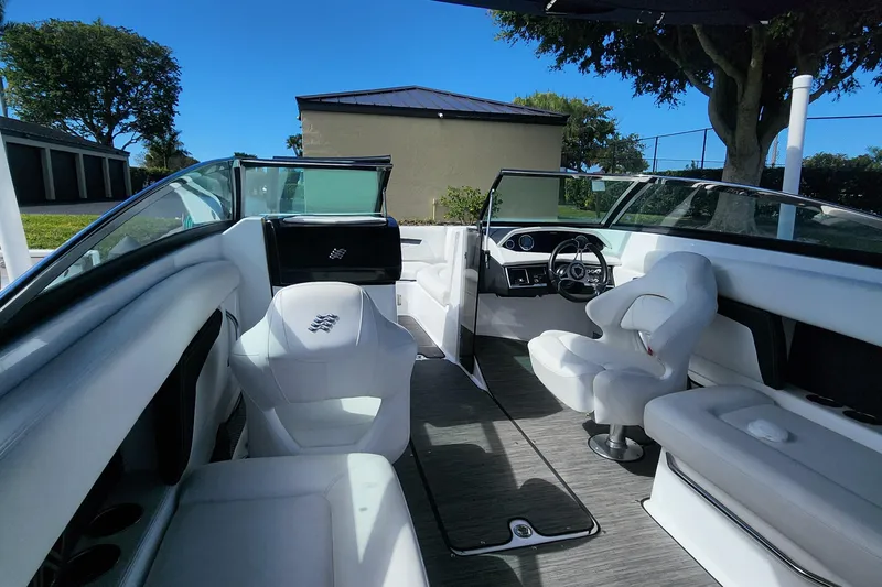 Slide: The Image of 2023 Four Winns HD8 OB boat interior with white seating and modern dashboard. - 24