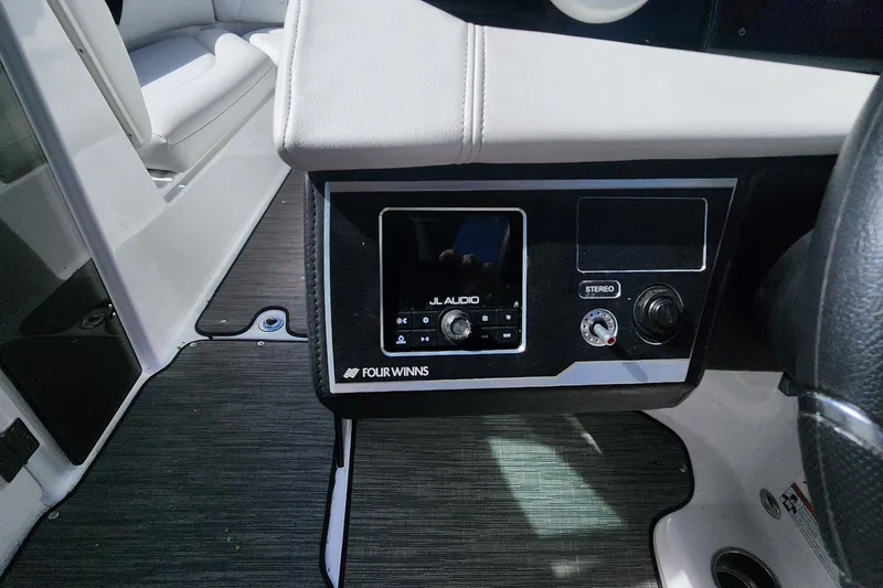 Slide: The Image of 2023 Four Winns HD8 OB boat dashboard with JL Audio system and stereo controls. - 25