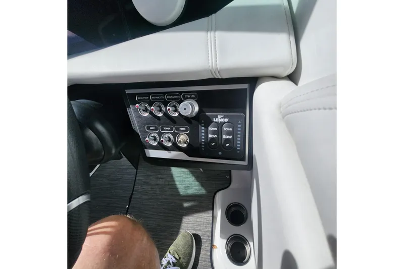 Slide: The Image of 2023 Four Winns HD8 OB boat dashboard with control panel and switches. - 26