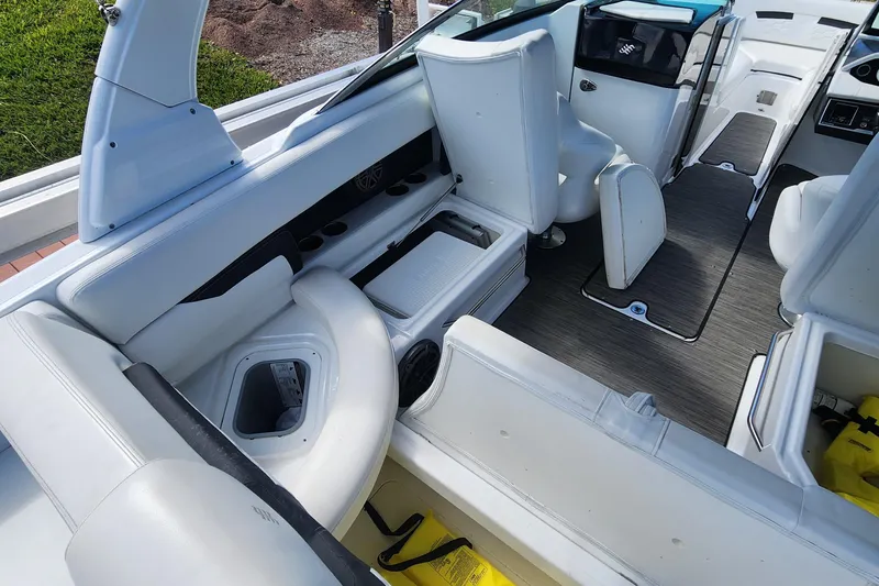 Slide: The Image of 2023 Four Winns HD8 OB boat interior with white seating and storage compartments. - 31