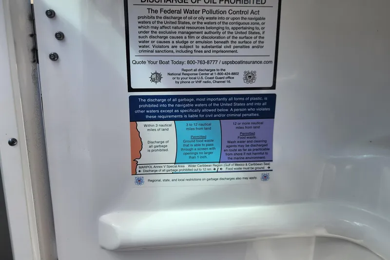 Slide: The Image of 2023 Four Winns HD8 OB boat warning label on waste discharge regulations and penalties. - 38