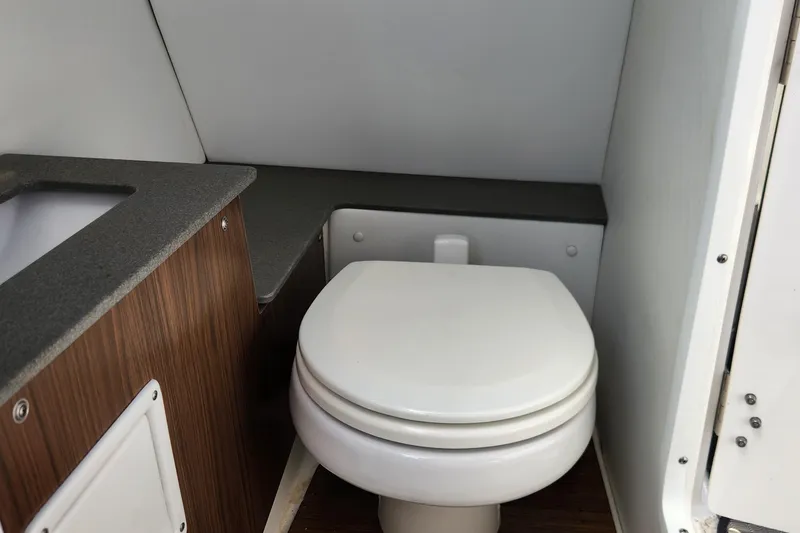Slide: The Image of 2023 Four Winns HD8 OB boat interior bathroom with toilet and sink. - 40