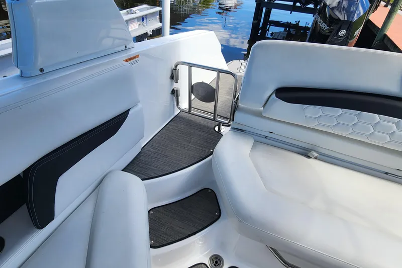 Slide: The Image of 2023 Four Winns HD8 OB boat interior with white seating and sleek design. - 45