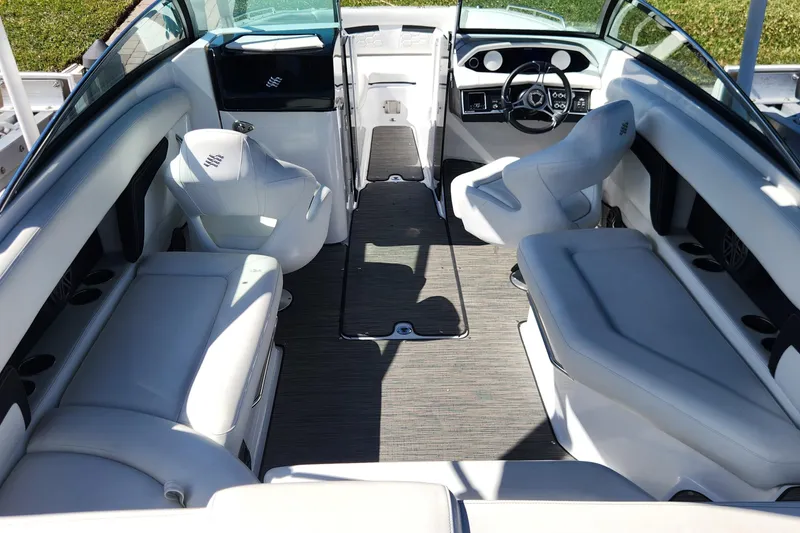 Slide: The Image of 2023 Four Winns HD8 OB boat interior with white seating and modern dashboard. - 5
