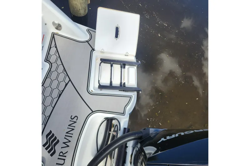 Slide: The Image of 2023 Four Winns HD8 OB boat deck with ladder and Mercury engine. - 51