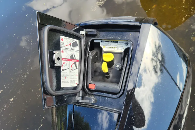 Slide: The Image of 2023 Four Winns HD8 OB engine compartment with open access panel and instructions. - 52