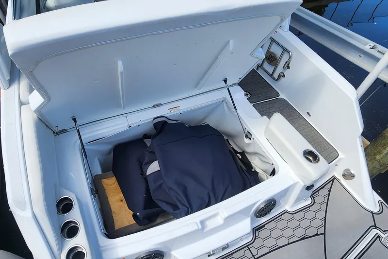 Slide: The Image of 2023 Four Winns HD8 OB boat storage compartment with open lid and interior view. - 55