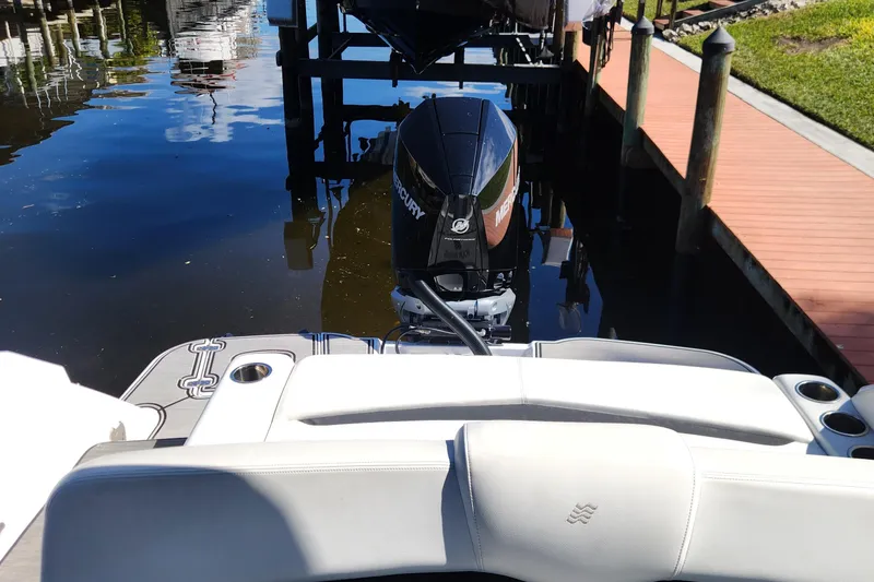 Slide: The Image of 2023 Four Winns HD8 OB boat with Mercury outboard engine docked by wooden pier. - 6