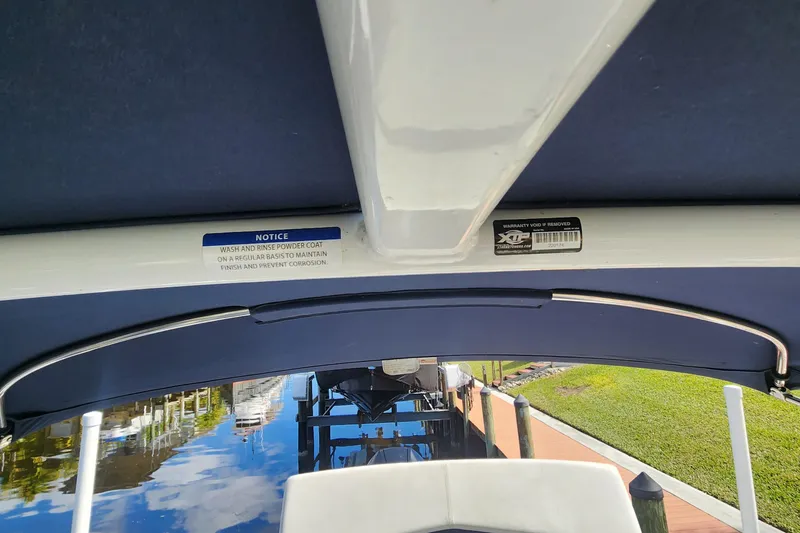 Slide: The Image of 2023 Four Winns HD8 OB boat interior with maintenance notice and warranty label. - 60