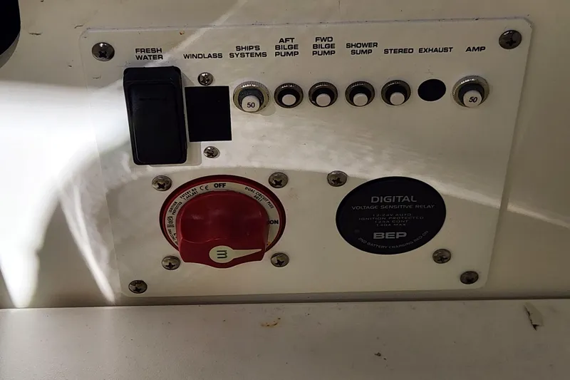 Slide: The Image of Control panel of 2023 Four Winns HD8 OB boat with switches and voltage relay. - 69